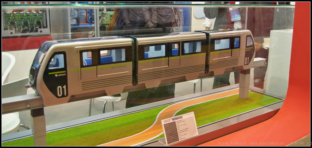 Model of Smart Monorail from Woojin Group, South Korea.

Am Messestand war ein Modell einer Monorail zu sehen, die sowohl ohne Füphrerstand (automatischer Betrieb) als auch mit Führerstand geliefert werden kann.  Die Anzahl der Module kann nach Wunsch variieren, mindestens jedoch zwei für einen Zug. Der Zug kann sowohl im Stadtverkehr, aber auch auf Ausstellungen oder Freizeitparks eingesetzt werden. Das Modell war während der InnoTrans 2014 am Stand von Woojin zu sehen.
